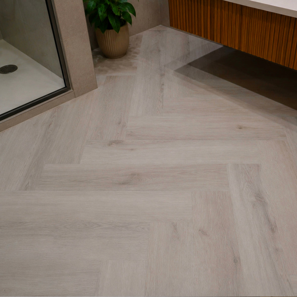 Arctic Silver Oak Herringbone Click LVT – laid in a bathroom