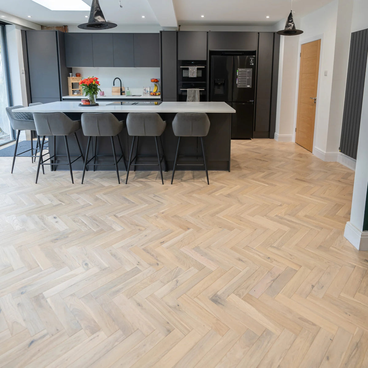 Worn Cathedral Oak 70mm Engineered Herringbone – laid in a kitchen