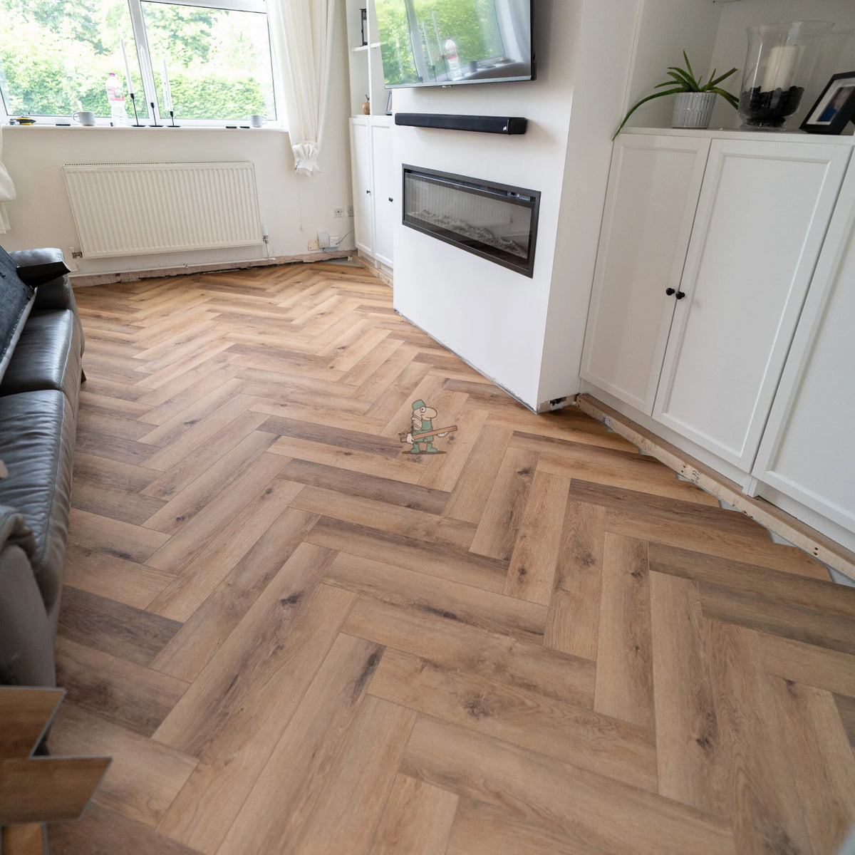 Warm Oak Herringbone Click LVT – laid in a living room