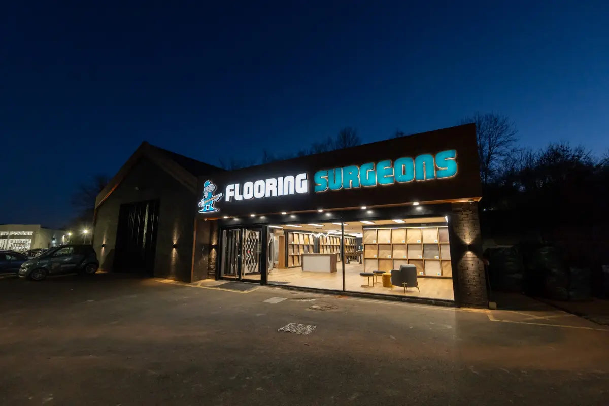 Flooring Surgeons showroom storefront at night