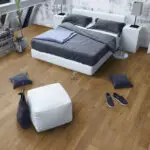 Light Smoked Oak Engineered Wood Flooring with a lacquered finish, showcasing warm golden tones and a textured surface.