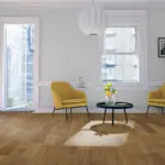Light Smoked Oak Engineered Wood Flooring with a lacquered finish, showcasing warm golden tones and a textured surface.