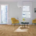 Natural Oak Heritage Herringbone flooring with a lacquered finish, offering timeless style and lasting durability.