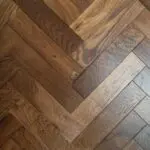 Grizzly Montreux Oak Herringbone Flooring with a brushed and lacquered double smoked finish