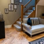 Elegant natural oak herringbone engineered wood flooring, featuring precise V-shaped patterns, rich wood textures, and a durable multi-layered construction