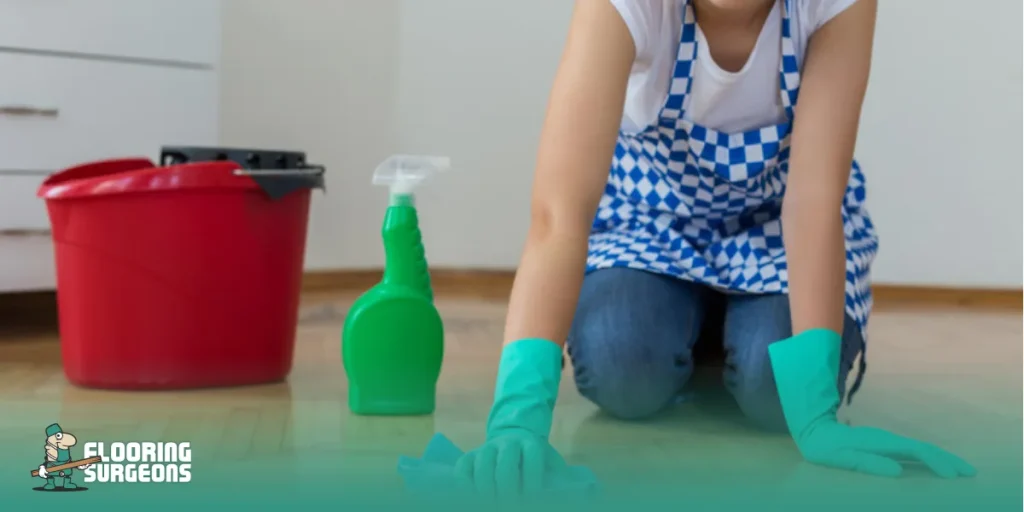 Woman cleaning a smooth, easy-to-clean home floor with cleaning supplies nearby