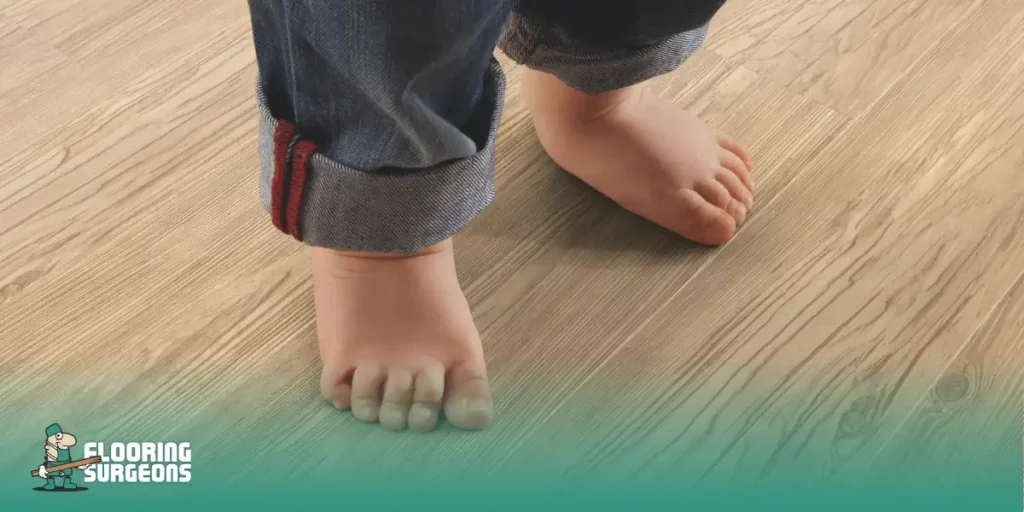 flooring and foot health Child’s bare feet standing on wood flooring, emphasizing comfort and stability underfoot.