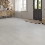 Arctic white oak laminate flooring installed in modern hallway with natural light