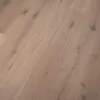 Close-up view of Nevada 14/3 x 190mm classic white oiled oak engineered wood flooring, featuring wide planks, natural knots, soft light tones, and textured wood grain pattern