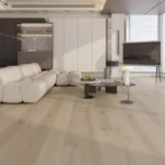Modern luxury living room with Nevada 14/3 x 190mm ivory washed oak engineered wood flooring, featuring wide planks, soft beige tones, natural grain texture, and contemporary furniture setup