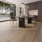 Modern dining area with Nevada 14/3 x 190mm smoked sawn oak engineered wood flooring, featuring wide planks, textured grain finish, warm brown tones, and stylish contemporary furniture