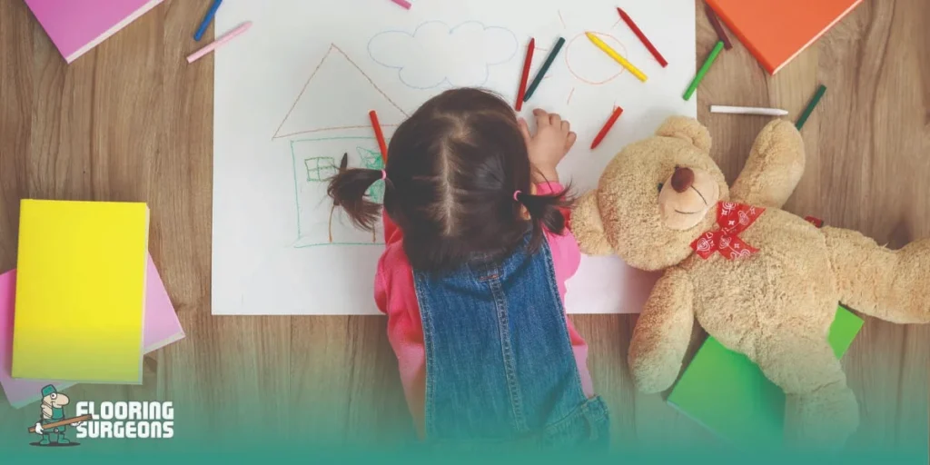 Designing a Child-Friendly Home Child lying on a wooden floor and coloring in a safe stylish living space