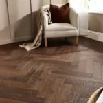 Espresso Oak Herringbone AC5 Laminate Flooring with rich dark brown wood grain.