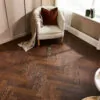 Espresso Oak Herringbone AC5 Laminate Flooring with rich dark brown wood grain.
